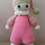 Cuddly baby with pink body and stripy arms and hat